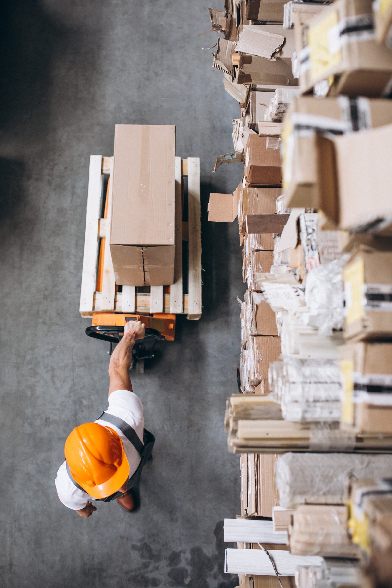 young man working warehouse with boxes scaled